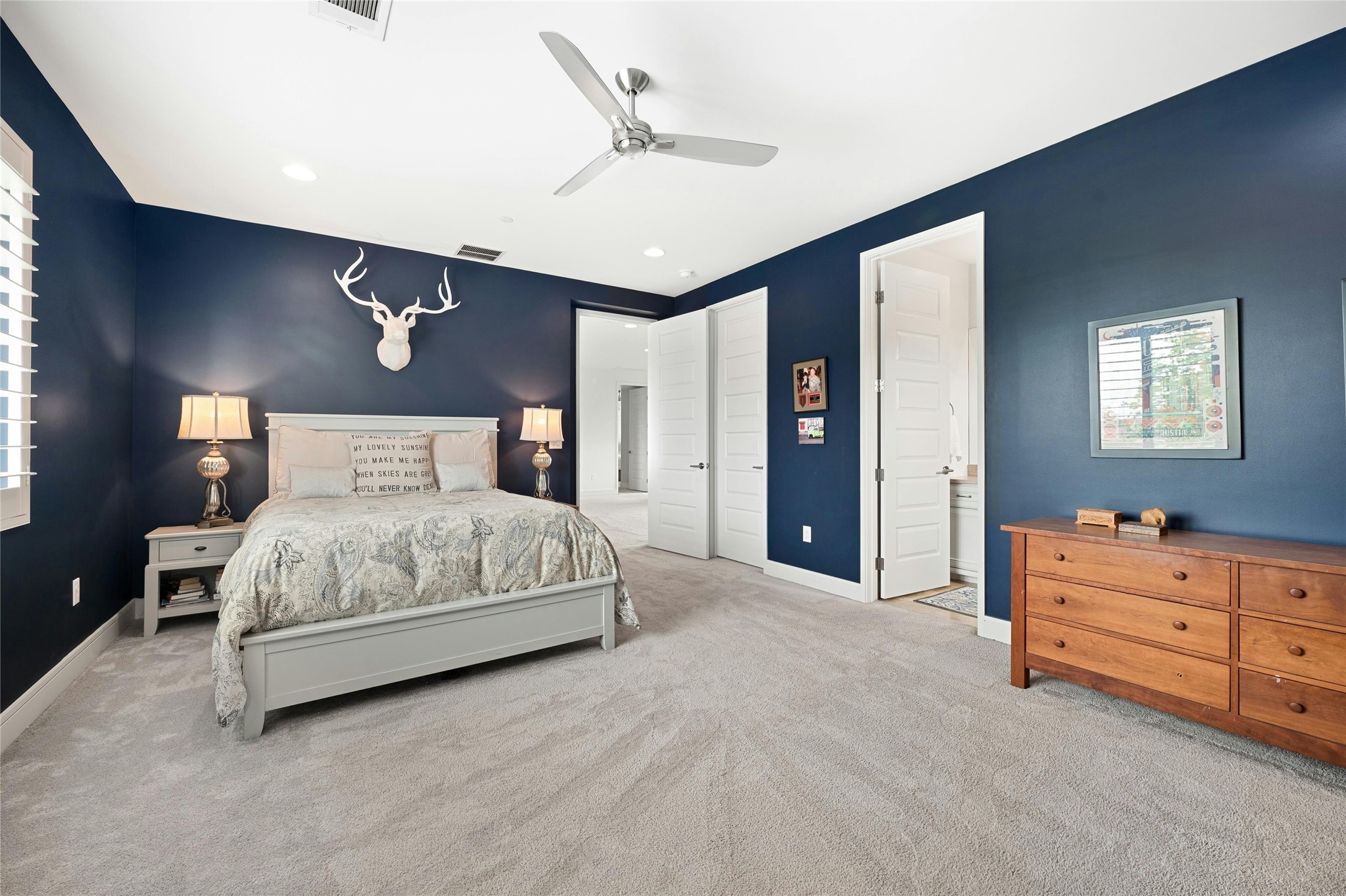 2201 Cypress Point West Austin, TX 78746 - Photo 24 of 37 a bedroom with a bed dresser and a ceiling fan