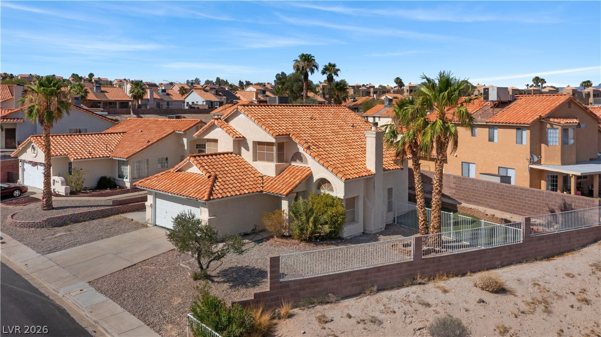 3156 Terrace View Drive Laughlin, NV 89029 - Photo 93 of 94 An aerial perspective reveals a Mediterranean-inspired residence with vibrant tile roofing and established palm trees.