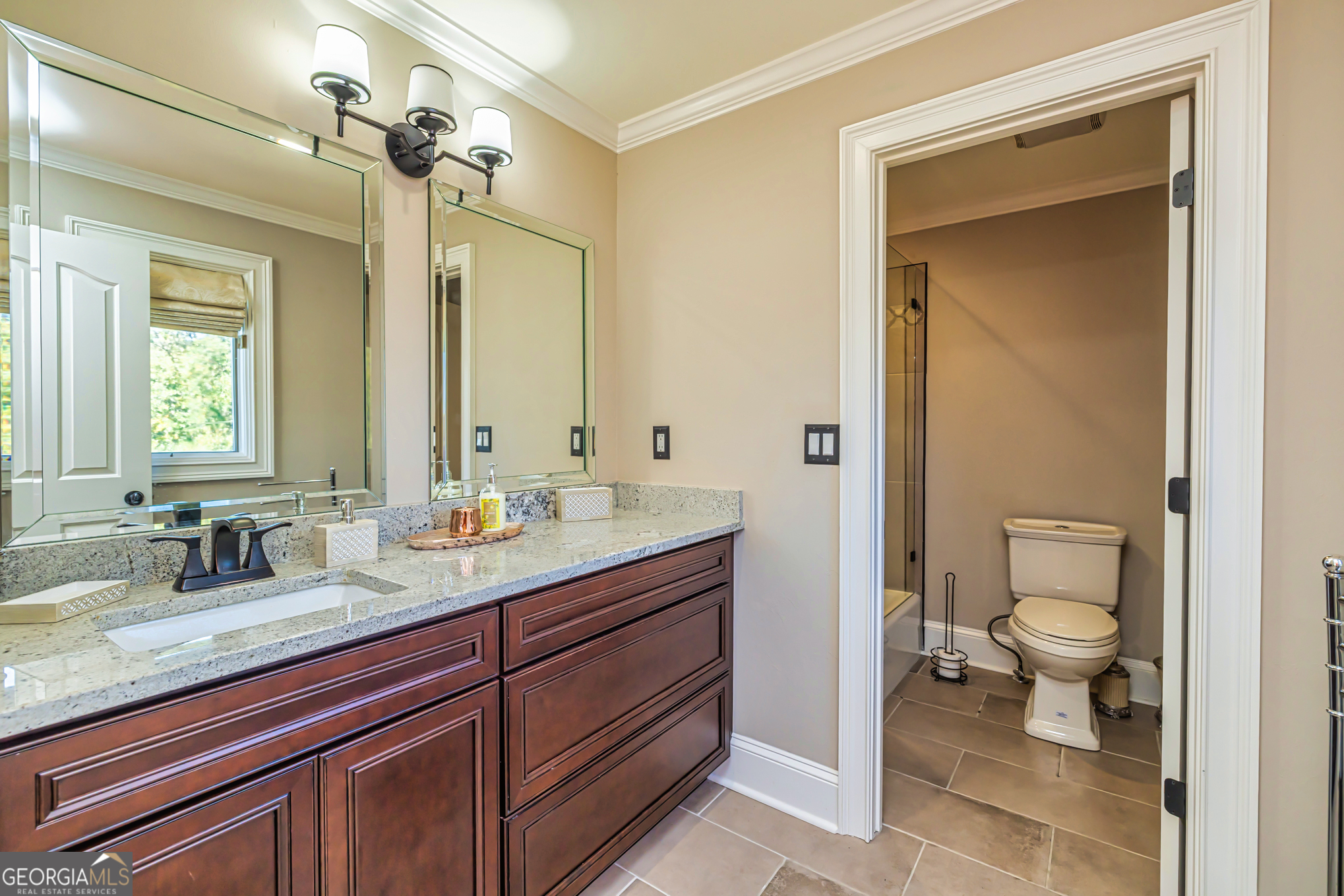 131 Lincoln Road Tyrone, GA 30290 - Photo 18 of 78 a bathroom with a granite countertop sink a toilet and a mirror