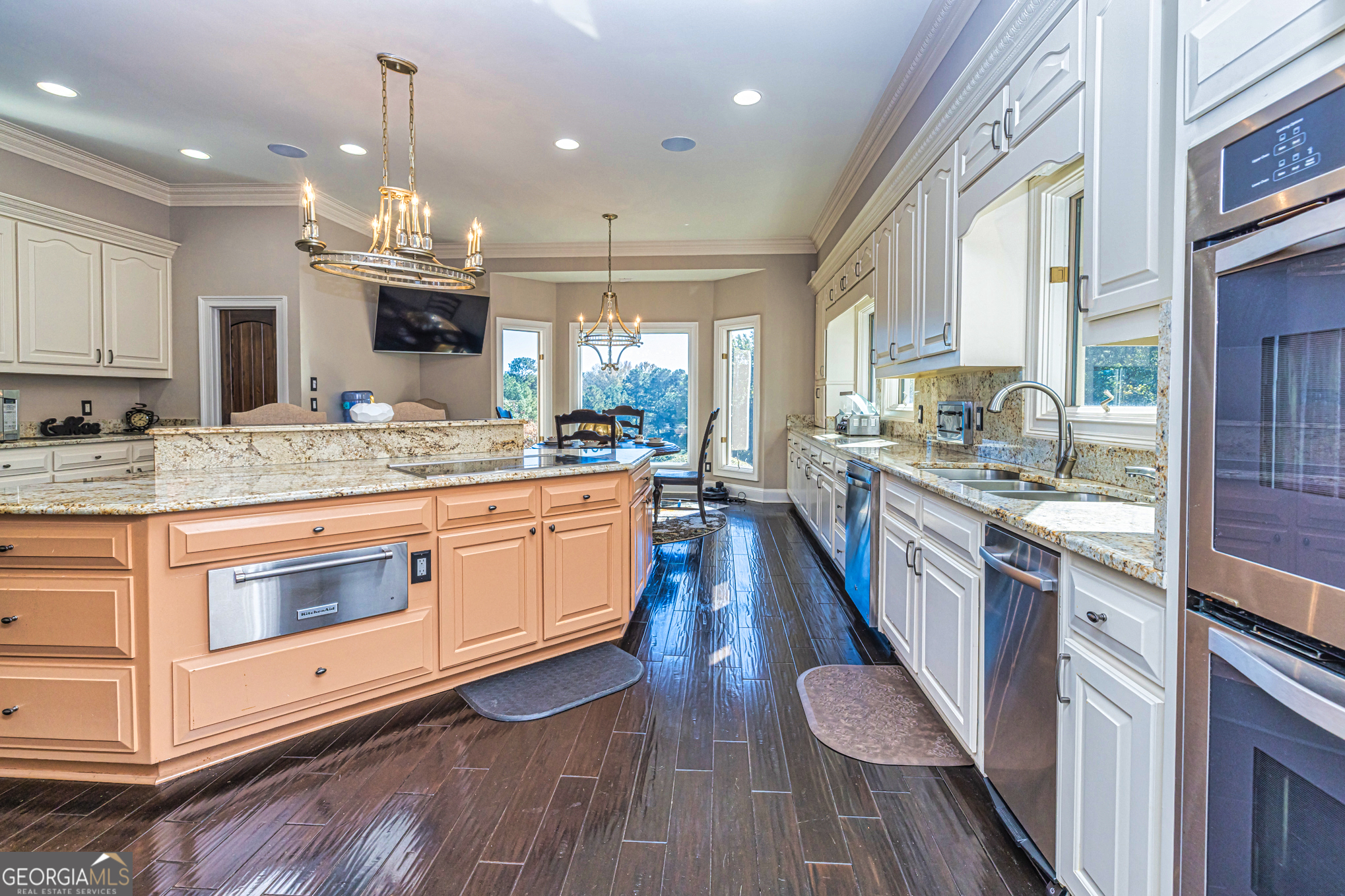 131 Lincoln Road Tyrone, GA 30290 - Photo 23 of 78 a large kitchen with stainless steel appliances a lot of counter space and a wooden floors