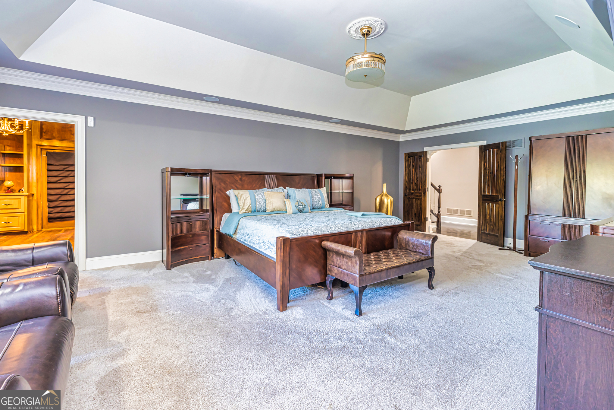 131 Lincoln Road Tyrone, GA 30290 - Photo 35 of 78 a bedroom with a bed and a chandelier