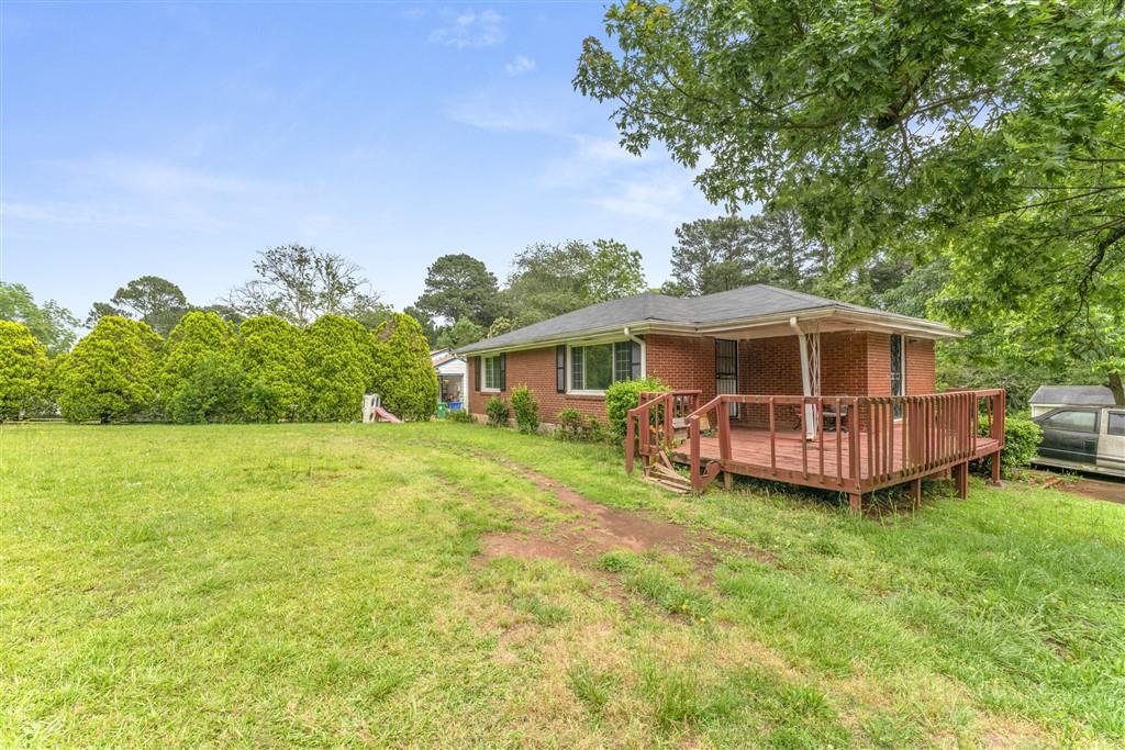 a view of a house with a yard and sitting area