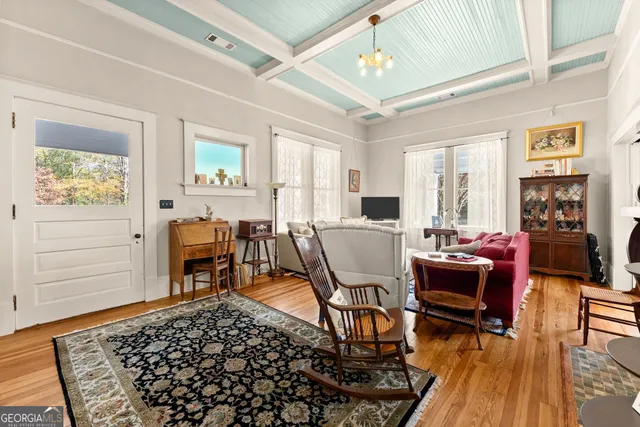 a living room with furniture a piano and a window