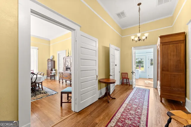 a view of a hallway with living room and dining room view