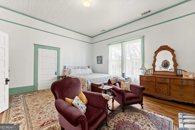 a living room with furniture a window and a rug