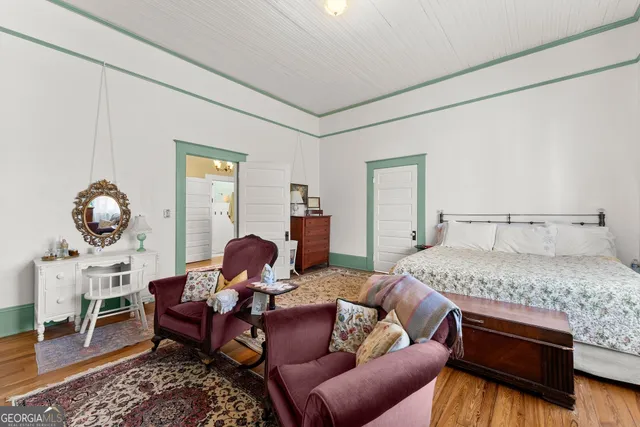 a bedroom with furniture and a wooden floor