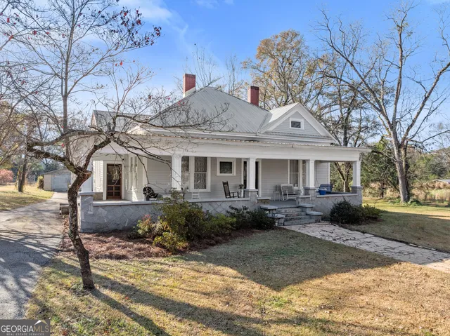 a front view of a house with garden and porch