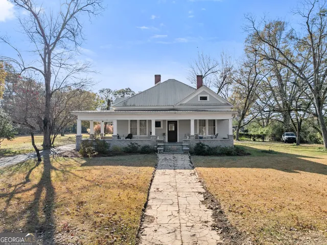 a front view of a house with a yard and porch