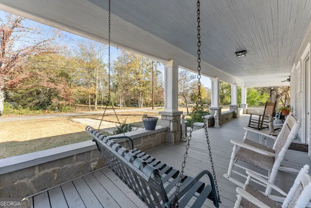 a living room with furniture and a floor to ceiling window