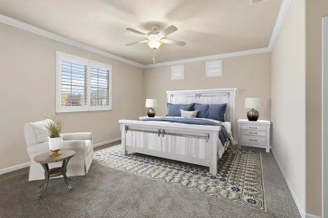 an empty room with a chandelier fan and windows