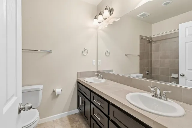 a bathroom with a shower a toilet and bathtub