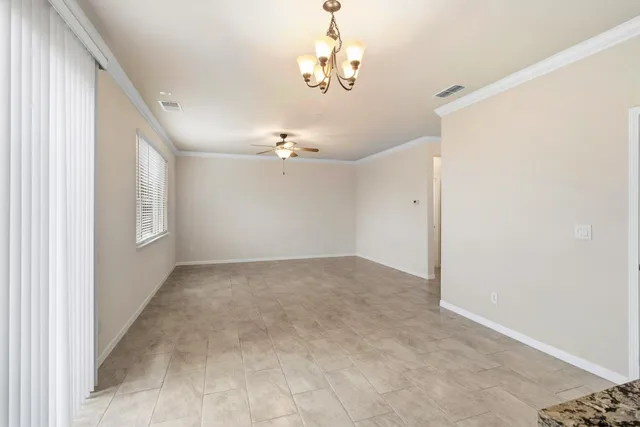 a view of an empty room with a kitchen