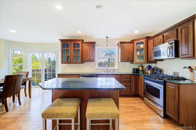a kitchen with a stove a sink a dining table and chairs