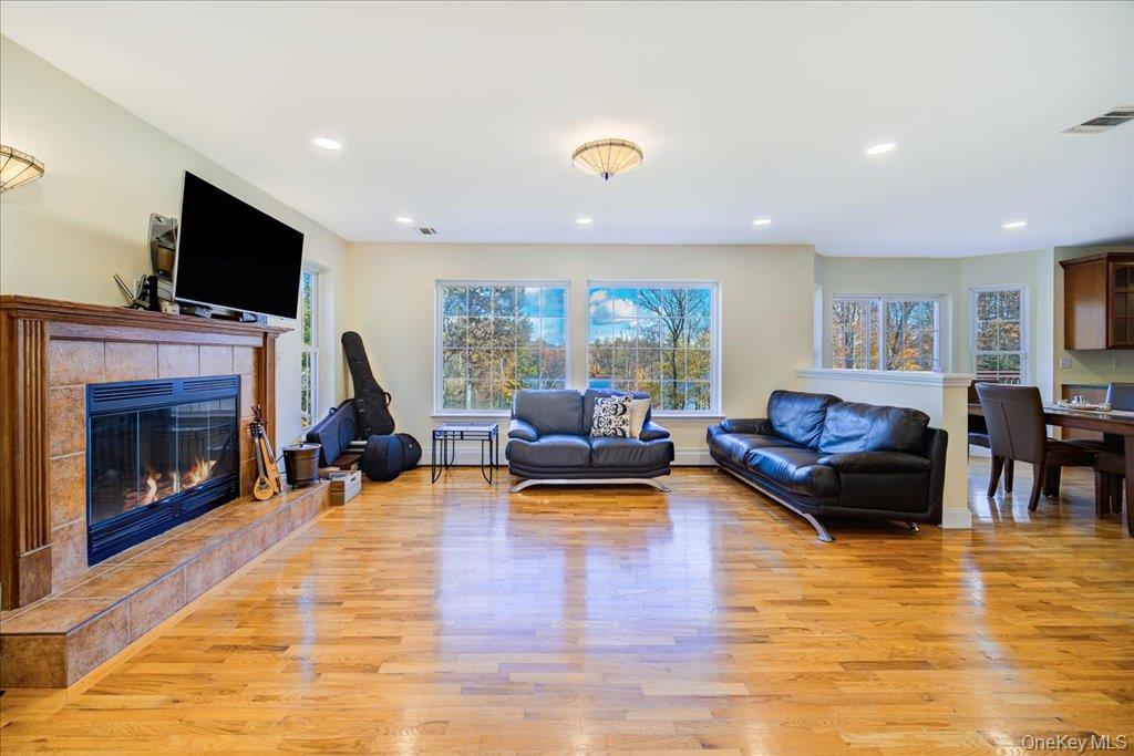 34 Twin Lakes Road Monroe, NY 10950 - Photo 14 of 35 a living room with furniture flat screen tv and a fireplace
