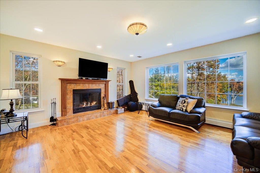 34 Twin Lakes Road Monroe, NY 10950 - Photo 15 of 35 a living room with furniture a flat screen tv and a fireplace