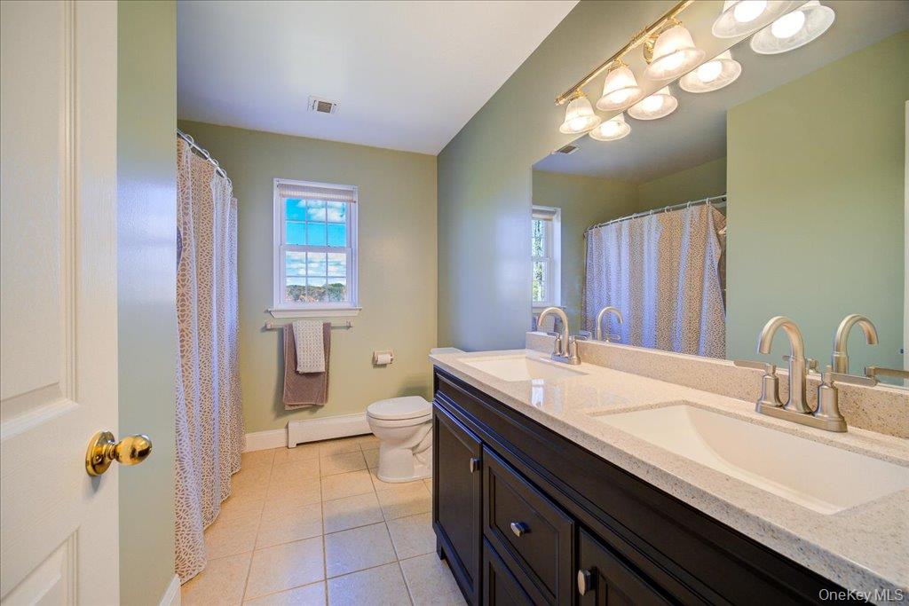 34 Twin Lakes Road Monroe, NY 10950 - Photo 22 of 35 a bathroom with a sink a toilet and a mirror