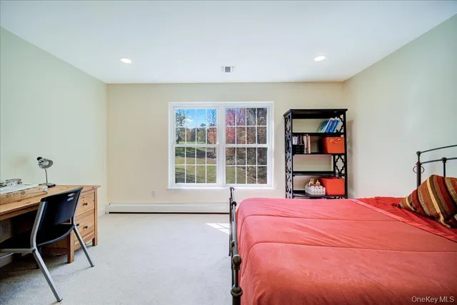 a bedroom with a bed and a bookshelf