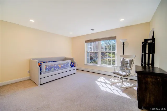 a living room with furniture a window and a flat screen tv