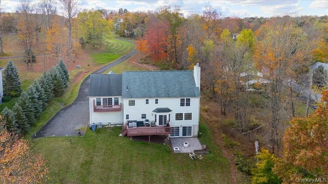 a aerial view of a house with swimming pool and a yard