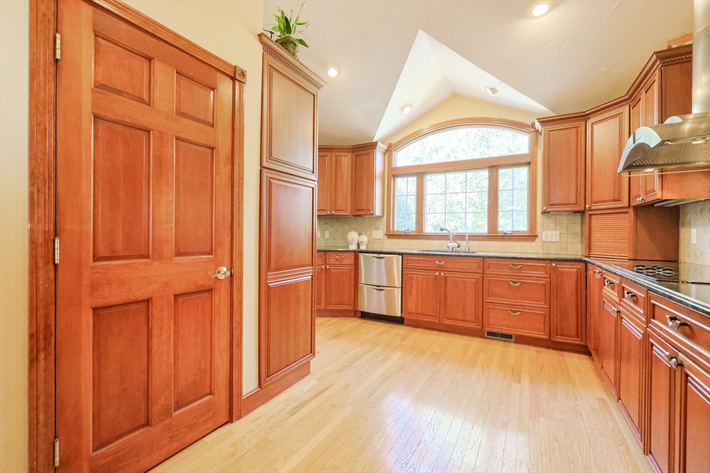 60 Deerfield Road Needham, MA 02492 - Photo 12 of 31 a large kitchen with stainless steel appliances a window and a refrigerator