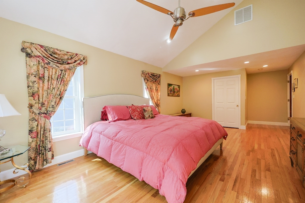60 Deerfield Road Needham, MA 02492 - Photo 22 of 31 a bedroom with a large bed and a chandelier