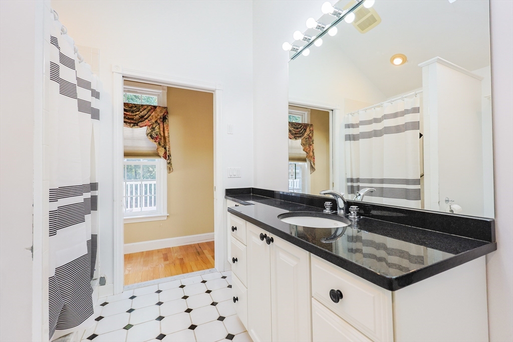 60 Deerfield Road Needham, MA 02492 - Photo 23 of 31 a bathroom with a granite countertop sink and a mirror