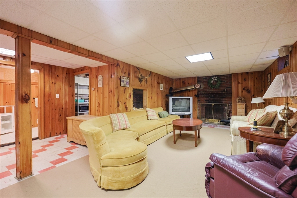 60 Deerfield Road Needham, MA 02492 - Photo 29 of 31 a living room with furniture a fireplace and a flat screen tv
