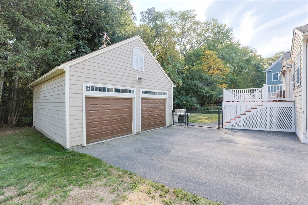 60 Deerfield Road Needham, MA 02492 - Photo 3 of 31 a view of a house with a yard and garage