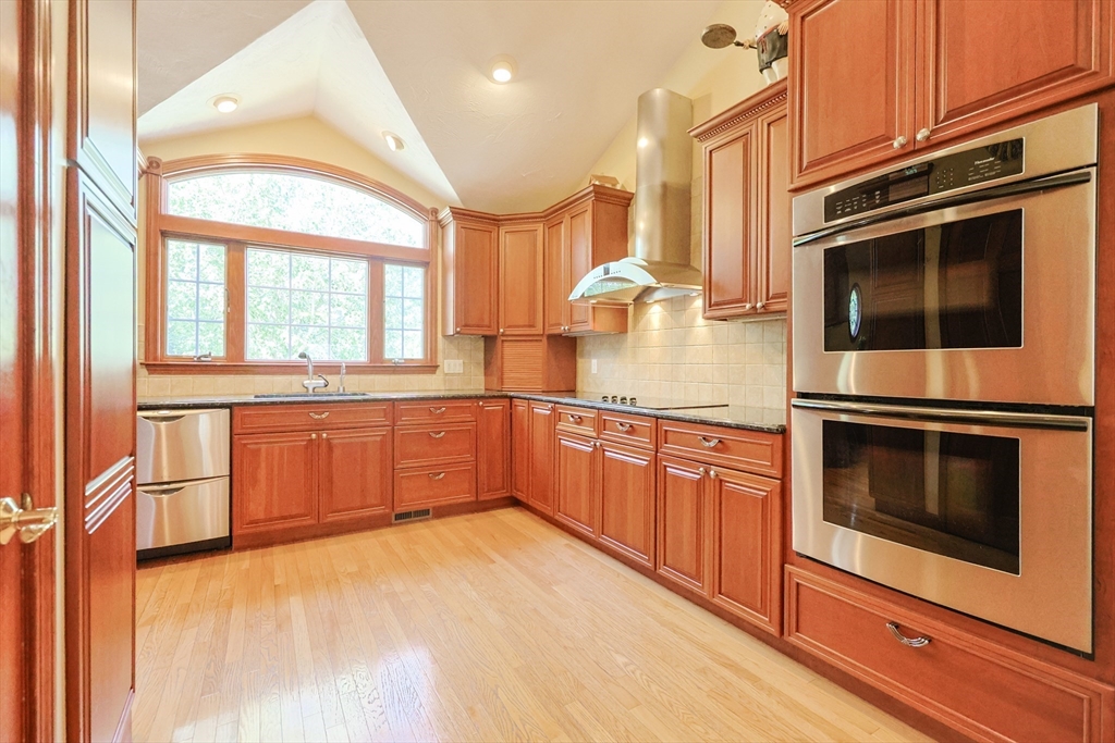 60 Deerfield Road Needham, MA 02492 - Photo 5 of 31 a kitchen with stainless steel appliances a stove a sink and a microwave