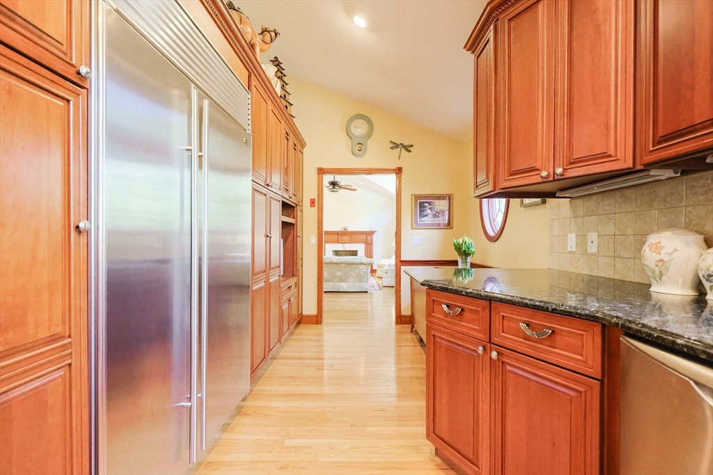60 Deerfield Road Needham, MA 02492 - Photo 6 of 31 a kitchen with granite countertop stainless steel appliances a refrigerator and cabinets