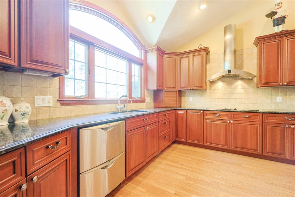 60 Deerfield Road Needham, MA 02492 - Photo 8 of 31 a kitchen with stainless steel appliances granite countertop a sink dishwasher cabinets and a large window