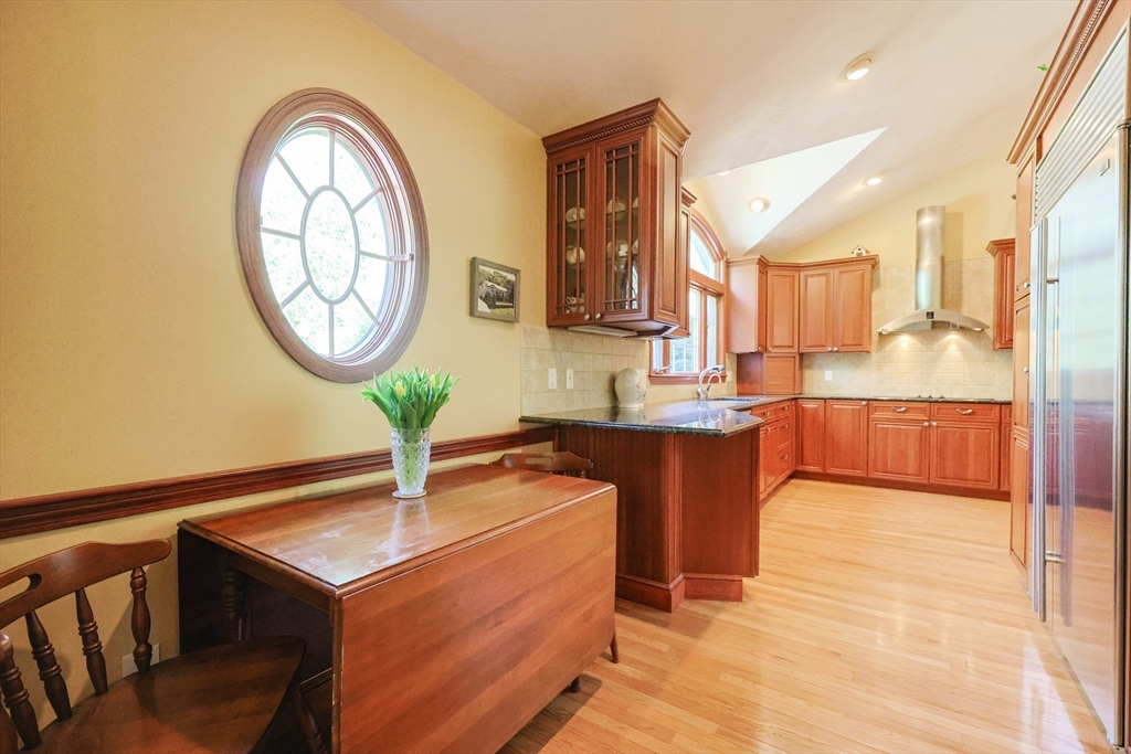 60 Deerfield Road Needham, MA 02492 - Photo 9 of 31 a kitchen with stainless steel appliances granite countertop a sink a stove and a wooden floors