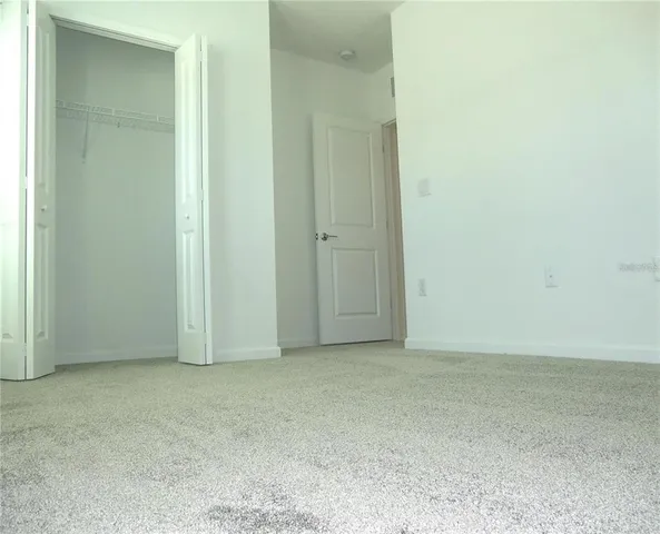 an empty room with closet area