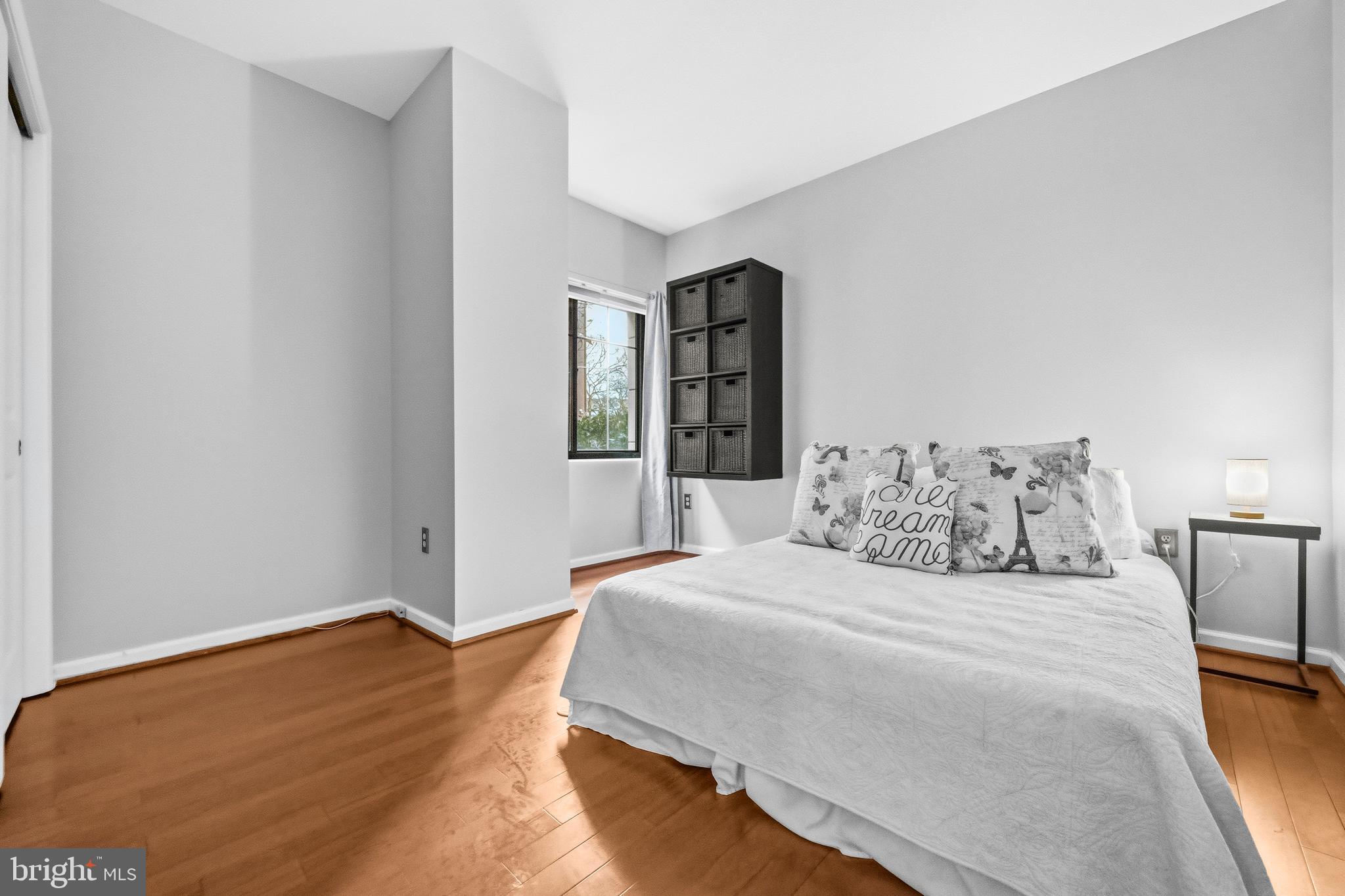 7923 Eastern Avenue Northwest, Unit 105 Silver Spring, MD 20910 - Photo 17 of 32 a bedroom with a large bed and a chandelier