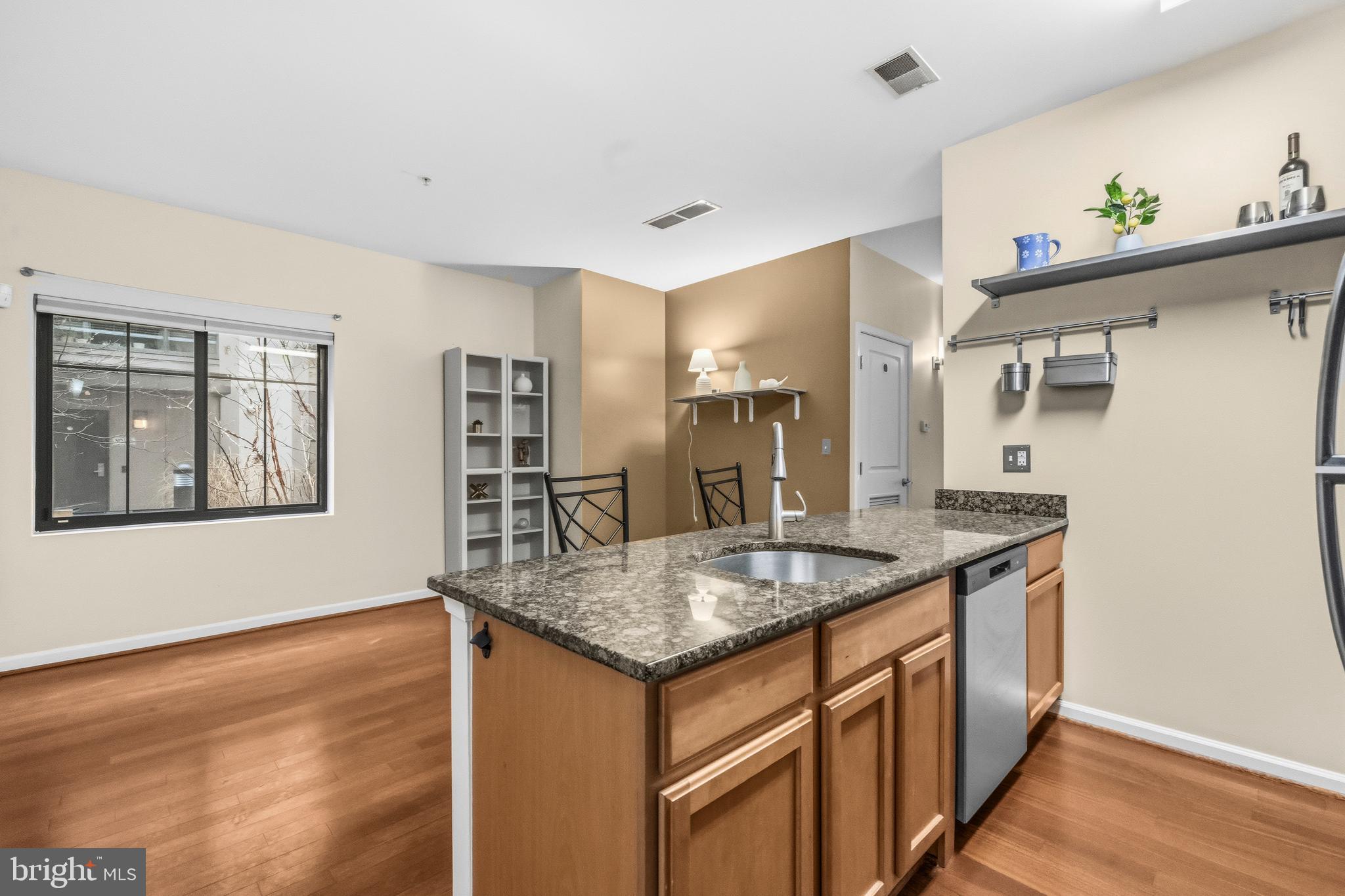 7923 Eastern Avenue Northwest, Unit 105 Silver Spring, MD 20910 - Photo 3 of 32 a kitchen with stainless steel appliances granite countertop a sink stove and refrigerator