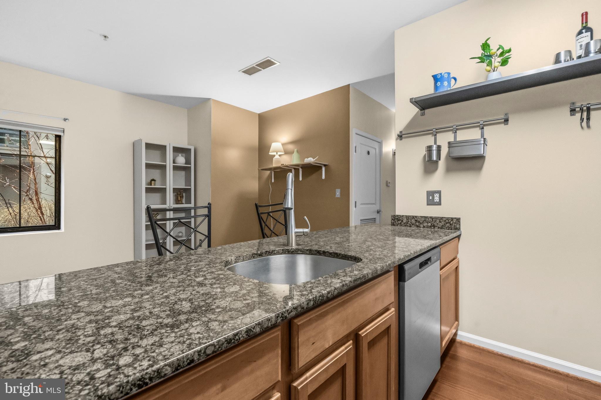 7923 Eastern Avenue Northwest, Unit 105 Silver Spring, MD 20910 - Photo 4 of 32 a kitchen with stainless steel appliances granite countertop a sink and a refrigerator