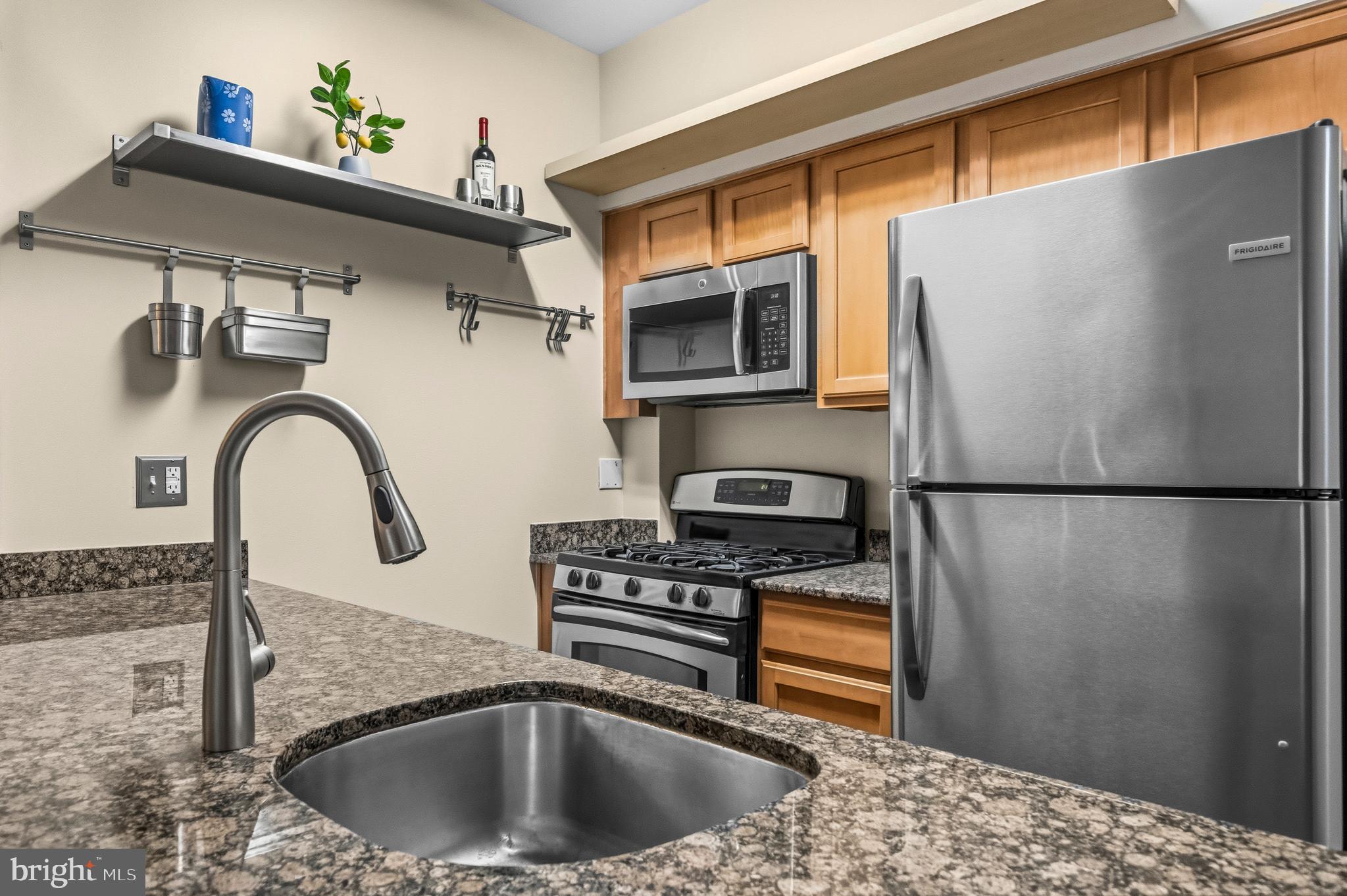 7923 Eastern Avenue Northwest, Unit 105 Silver Spring, MD 20910 - Photo 10 of 32 a kitchen with a refrigerator and a sink