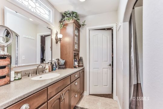 1220 Jennifer Court Ridgecrest, CA 93555 - Photo 26 of 34 a bathroom with a double vanity sink and a mirror