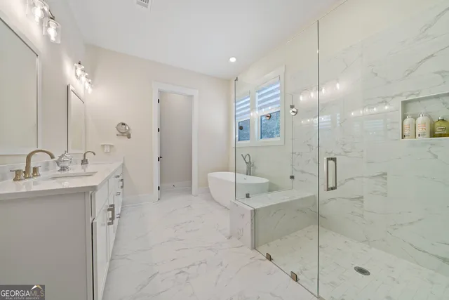 a bathroom with a shower sink and mirror