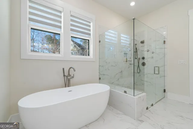 a white bath tub sitting next to a bathroom