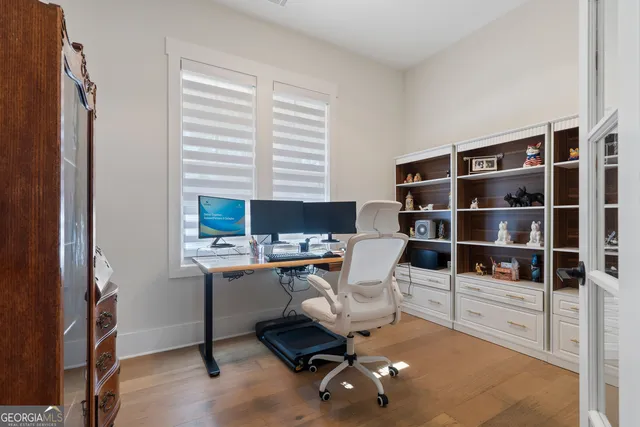 a view of a workspace with furniture and a window