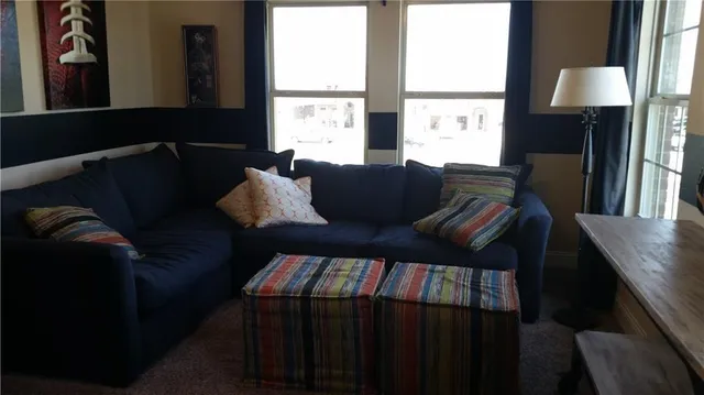 a living room with furniture lamp and window