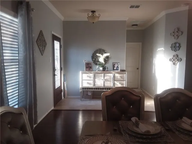 a living room with furniture and chandelier