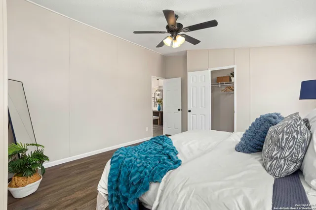 a bedroom with a bed chandelier and a window