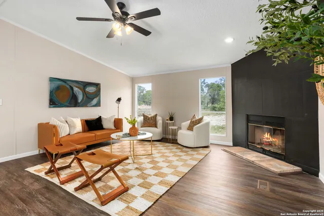 a living room with furniture and a fireplace