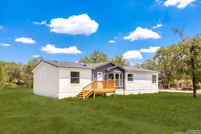 a view of a house with a backyard
