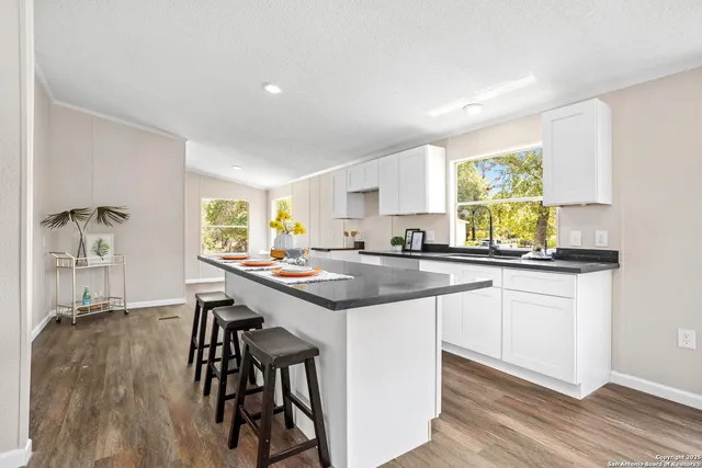 a kitchen with a sink cabinets and window