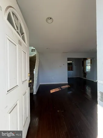 a view of a livingroom with wooden floor and a window