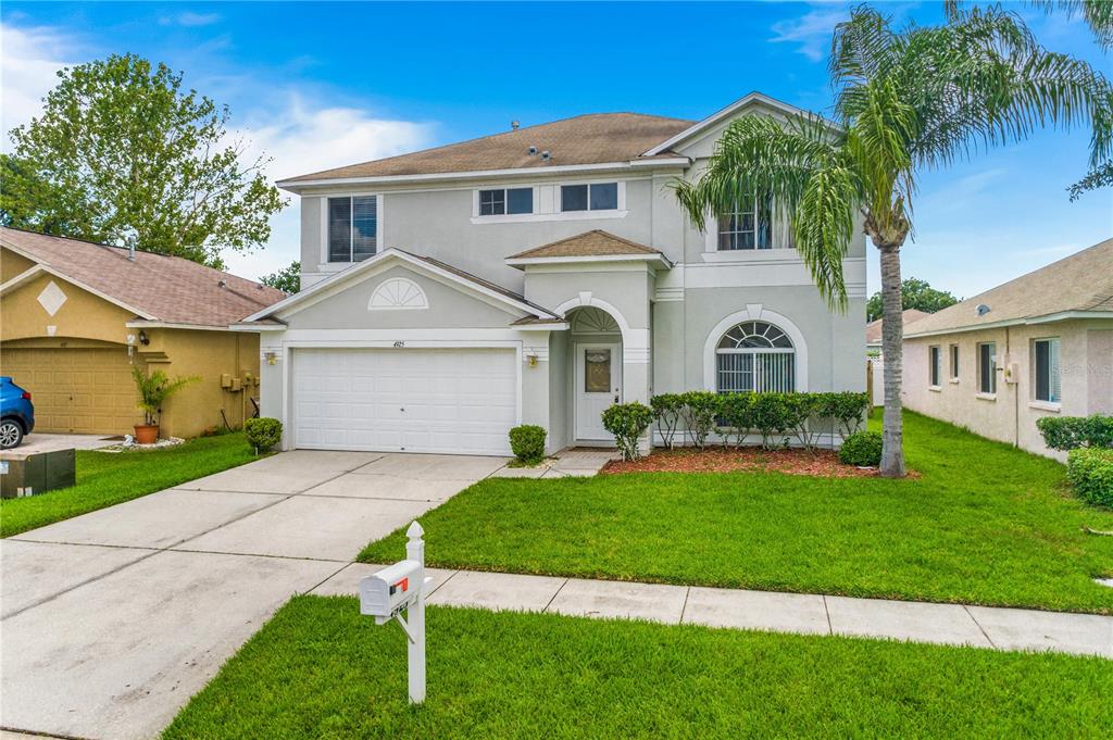 4925 Woodmere Road Land O Lakes, FL 34639 - Photo 1 of 1 a front view of a house with a yard and garage