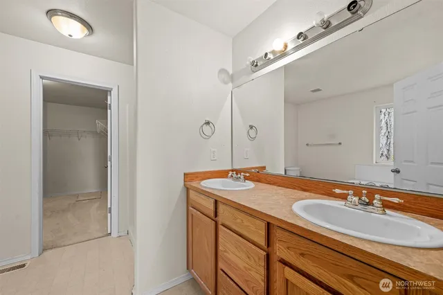 a bathroom with a sink double vanity and a mirror